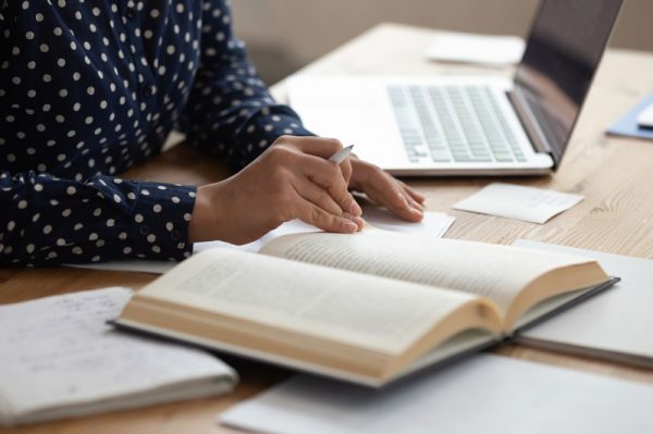 Close up of a person sitting at desk reading